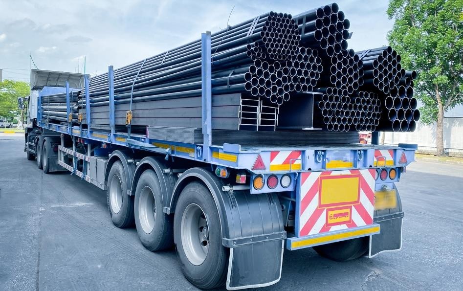 Flatbed trailer loaded with steel pipes